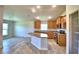 Kitchen with island, wood cabinets, and stainless steel appliances at 1269 Tagliamento Ln, Haines City, FL 33844