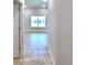 Bright hallway with tile flooring and access to other rooms at 1269 Tagliamento Ln, Haines City, FL 33844
