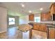 Kitchen boasts an island, wood cabinets, and stainless steel appliances at 1269 Tagliamento Ln, Haines City, FL 33844