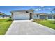 Single-story home with attached garage and driveway at 1269 Tagliamento Ln, Haines City, FL 33844