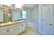 Elegant bathroom featuring double sinks, garden tub, and walk-in shower at 1265 Tagliamento Ln, Haines City, FL 33844