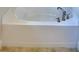 Clean bathroom with corner soaking tub and tile flooring at 1265 Tagliamento Ln, Haines City, FL 33844