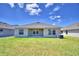 Rear view of house showing covered patio and yard at 1265 Tagliamento Ln, Haines City, FL 33844