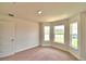 Bedroom with bay window, carpet and door to hallway at 1265 Tagliamento Ln, Haines City, FL 33844