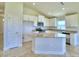 Kitchen with island, white cabinets, and granite countertops at 1253 Tagliamento Ln, Haines City, FL 33844