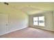 Well-lit bedroom featuring carpeted floors and a window at 1253 Tagliamento Ln, Haines City, FL 33844