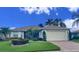Single-story home with attached garage and well-manicured landscaping at 3093 Dunmore Dr, Lake Wales, FL 33859