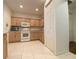 Kitchen with white appliances and light wood cabinets at 3093 Dunmore Dr, Lake Wales, FL 33859