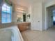 Bathroom with soaking tub and double vanity at 3093 Dunmore Dr, Lake Wales, FL 33859