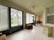 Bright sunroom with tiled floors, seating and backyard view at 3093 Dunmore Dr, Lake Wales, FL 33859