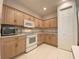 Kitchen with light wood cabinets and appliances at 3093 Dunmore Dr, Lake Wales, FL 33859