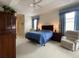 Main bedroom with a king-size bed and sitting area at 3093 Dunmore Dr, Lake Wales, FL 33859
