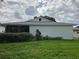 White house exterior with well-maintained lawn and landscaping at 3130 Prairie Dunes W Cir, Lakeland, FL 33810