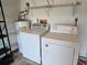 Garage laundry area with washer, dryer and water heater at 3130 Prairie Dunes W Cir, Lakeland, FL 33810