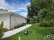 Landscaped side yard with walkway and AC unit at 3130 Prairie Dunes W Cir, Lakeland, FL 33810