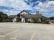 Exterior view of community clubhouse with parking lot at 3130 Prairie Dunes W Cir, Lakeland, FL 33810