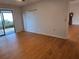Bedroom with wood flooring, sliding patio doors and ceiling fan at 3130 Prairie Dunes W Cir, Lakeland, FL 33810