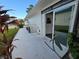 Concrete patio with access to Florida room and backyard at 3130 Prairie Dunes W Cir, Lakeland, FL 33810