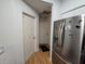 A view down a hallway with doors to other rooms and a refrigerator at 3130 Prairie Dunes W Cir, Lakeland, FL 33810