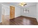 Bedroom with wood-look floors, ceiling fan and access to hallway at 1510 Richmond Rd, Lakeland, FL 33801