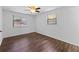Bedroom with wood-look floors and two windows with blinds at 1510 Richmond Rd, Lakeland, FL 33801