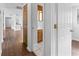 Hallway with wood-look floors and access to multiple rooms at 1510 Richmond Rd, Lakeland, FL 33801