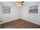 Bedroom with wood-look floors, ceiling fan, and two windows at 1510 Richmond Rd, Lakeland, FL 33801