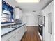 Kitchen boasts white cabinets, wood-look floors, and a view into the dining area at 1510 Richmond Rd, Lakeland, FL 33801
