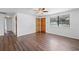 Living room features wood-look floors, a ceiling fan, and large window at 1510 Richmond Rd, Lakeland, FL 33801