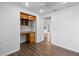 Bedroom with wood-look floors, built-in desk, and access to other rooms at 1510 Richmond Rd, Lakeland, FL 33801