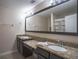 Double vanity bathroom with granite countertops and large mirror at 8153 Roseville Rd, Davenport, FL 33896