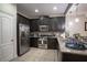 Modern kitchen with dark wood cabinets and granite countertops at 8153 Roseville Rd, Davenport, FL 33896