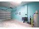 Attached garage with light teal walls and ample storage space at 8153 Roseville Rd, Davenport, FL 33896