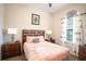 Bright bedroom with a comfortable bed and wood furniture at 8153 Roseville Rd, Davenport, FL 33896