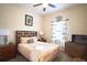 Bright bedroom with a comfortable bed and wood furniture at 8153 Roseville Rd, Davenport, FL 33896