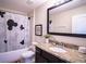 Clean bathroom, granite countertop, and Mickey Mouse shower curtain at 8153 Roseville Rd, Davenport, FL 33896