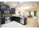 Modern kitchen with dark cabinets and stainless steel appliances at 8153 Roseville Rd, Davenport, FL 33896