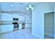 Open concept kitchen with white cabinets and a walk-in pantry at 1273 Tagliamento Ln, Haines City, FL 33844