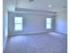 Spacious bedroom with multiple windows and carpet flooring at 1261 Tagliamento Ln, Haines City, FL 33844