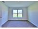 Simple bedroom with carpeted floors and a large window at 1261 Tagliamento Ln, Haines City, FL 33844