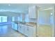 Modern kitchen with white cabinets, granite countertops, and stainless steel appliances at 1261 Tagliamento Ln, Haines City, FL 33844