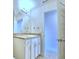 Bathroom with white vanity, granite countertop, and a linen closet at 1261 Tagliamento Ln, Haines City, FL 33844