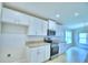 Bright kitchen featuring white cabinets, granite countertops, and stainless steel appliances at 1261 Tagliamento Ln, Haines City, FL 33844
