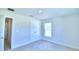 Bedroom with carpet flooring, window, and door to bathroom at 1261 Tagliamento Ln, Haines City, FL 33844
