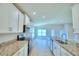 Modern kitchen with granite countertops and white cabinets at 1261 Tagliamento Ln, Haines City, FL 33844