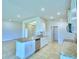 Spacious kitchen with an island, white cabinets, and granite countertops at 1261 Tagliamento Ln, Haines City, FL 33844