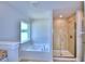 Bathroom with soaking tub and walk-in shower at 1261 Tagliamento Ln, Haines City, FL 33844