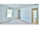 Bedroom with carpeted floors and access to bathroom at 1261 Tagliamento Ln, Haines City, FL 33844
