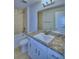 Bathroom with white vanity, granite countertop, and shower/tub combo at 1261 Tagliamento Ln, Haines City, FL 33844