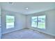 Bedroom with two windows and carpet flooring at 1261 Tagliamento Ln, Haines City, FL 33844